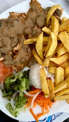 traditional portuguese cuisine, fish, meat with mushrooms, salad and fried potatoes and rice