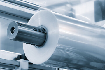 Automatic polyethylene plastic bag production machine with lighting effect. Close-up of the roller...