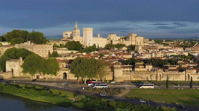 View of Avignon with Palais des Papes during sunset in Southern France. Medieval architecture along the Rhone River in Avignon, Provence, France. The Palais des Papes in Avignon, South France.