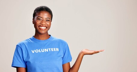 Black woman, portrait or volunteer with hand out in studio for charity or community service on a...