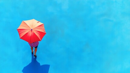 Colorful street scene with a top view of a person walking with an umbrella against a blue background