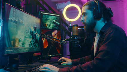 Caucasian gamer man addict puzzled influencer streaming play videogame blog computer screen...