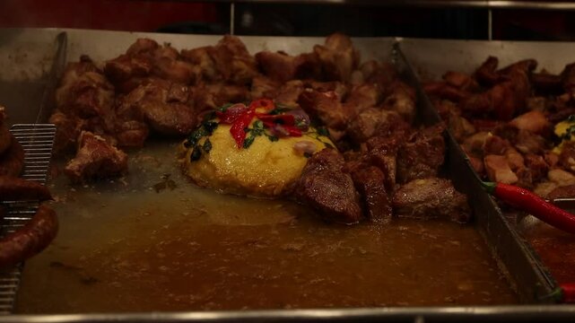 Romanian cuisine, master chef prepares dishes with fried and smoked meats, french fries