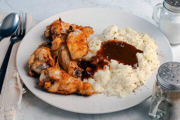 chicken  wings and drumsticks  with mashed potatoes