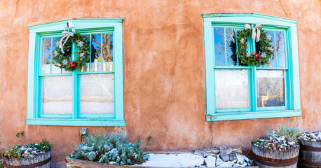Fototapeta premium Blue Windows and Snow With Adobe Architecture on Historic Canyon Road, Sante Fe, New Mexico, USA