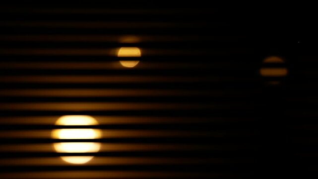 Flickering lights with visible shutter effects create streaks and blurred lines in the frame. Defect. The interplay of light and movement adds a surreal and abstract quality to the video. 