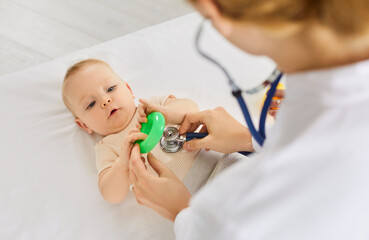 Pediatrician medical doctor exam, checking baby heartbeat, lungs using stethoscope, treats newborn...