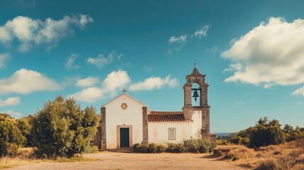 Fototapeta premium A picturesque view of a bell tower against a vibrant blue sky dotted with wispy clouds.