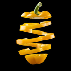 flying yellow bell pepper slices. isolated on black background, png. 