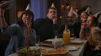 Family sit at table at home, grandchildren and parents celebrating birthday of grandfather, family...