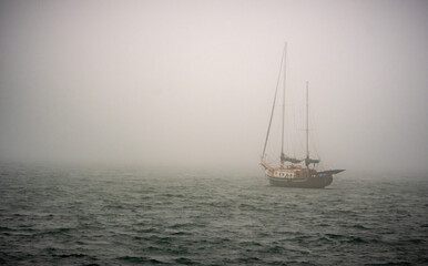 Sailing Ship On Open Water In Morning Fog