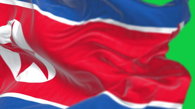 Close-up of North Korea national flag waving isolated on green background