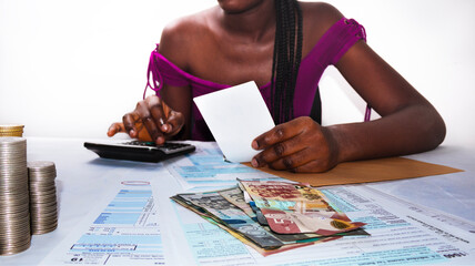 Young black african female lady woman wearing Purple top sitting at office desk holding paper...