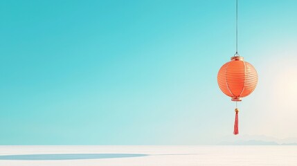 Fototapeta premium A vibrant red lantern sways gently against a clear blue sky, symbolizing celebration and tradition in many cultures, offering a serene visual experience.