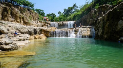 Naklejka premium Tranquil Waterfall Pool Surrounded By Lush Green Foliage
