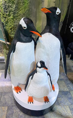 Three Penguin statues on ice floes