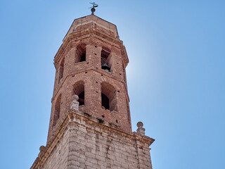 Close-up of the brick and stone Bell Tower of the Church of the Savior, El Salvador in Spanish....