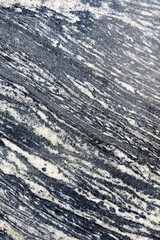 The blue, gray and white patterns of natural marble or marble with lines and waves of color make it look natural and fluid. The pattern is complex texture and blackglound.