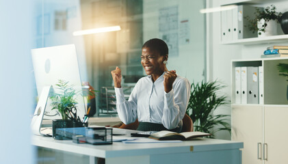 Happy, black woman or night with computer for winning, promotion or celebration at office. Excited, African or female person with smile or fist pump for victory, achievement or good news at workplace