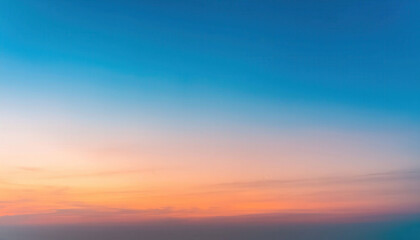 Fototapeta premium A gradient sky background transitioning from pale orange to soft blue, evoking a calm and atmospheric mood, perfect for serene, peaceful, and tranquil designs.