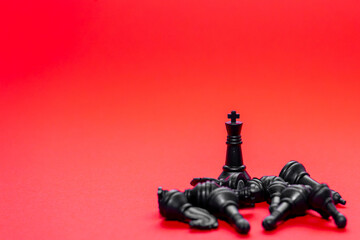 Chess pieces scattered around a lone king against a vibrant background