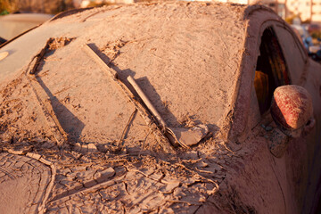 Car covered with mud after a once in a century flood in Valencia, Spain