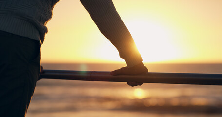 Hand, railing and reflection at beach, sunset and promenade in summer with blur, mindset and insight on vacation. Pier, person and inspiration by sea, ocean and outdoor by water at dusk in Costa Rica