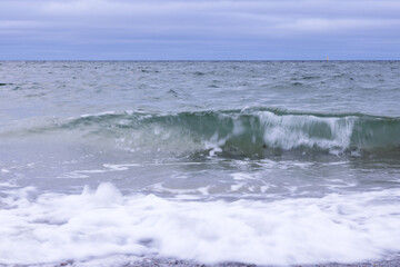 Lone sail on the horizon in the North Sea on a gloomy autumn day