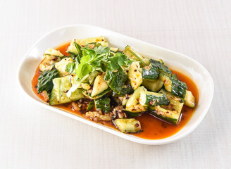 Spicy Hand crushed cucumber salad with garlic and hot and sour sauce served in tray dish isolated on white background side view of hong kong food