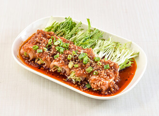 Garlic Pork rolls topped with herbs, green onion and sesame seeds served in tray dish isolated on white background side view of hong kong food
