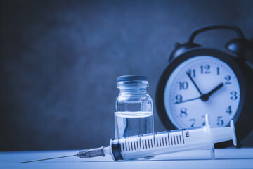 Time for vaccination. Watch and syringe with vaccine. Date and time of preventive vaccinations to...