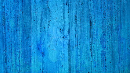 Obraz premium a cold, textured travertine stone wall with a blue background, ideal for creating a classic and elegant ambiance in interior design projects, background for timeless, sophisticated aesthetic concept.