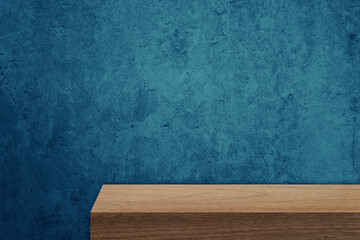 edge of brown wooden counter with blank space for product montage display with rustic blue stucco concrete wall at background. border of wood table for decoration. front view elevation of table.