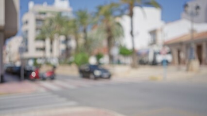 City street with blurred buildings and cars in the background on a sunny day