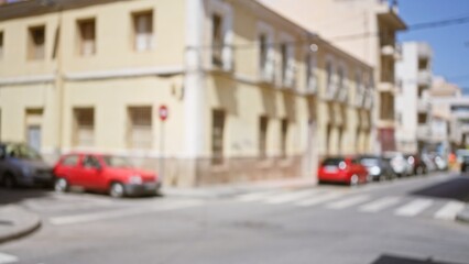 Blurry street scene in a city with parked cars and old buildings on a sunny day, highlighting bokeh and blur in an outdoor urban environment