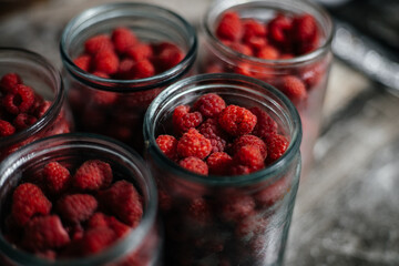 Raspberries in a glass jar. Preparation for making jam or compote. Home canning