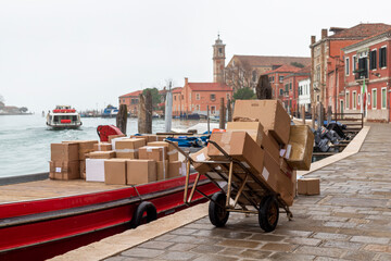 Boat Loading Packages for Maritime Transport un Murano, Venice Skyline Italy