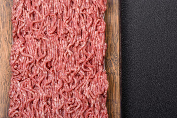 Fresh raw ground minced beef with salt and spices