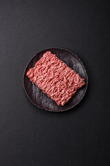 Fresh raw ground minced beef with salt and spices