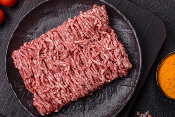 Fresh raw ground minced beef with salt and spices