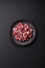 Raw chicken hearts with salt, spices and herbs