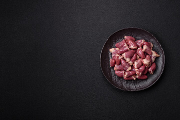 Raw chicken hearts with salt, spices and herbs