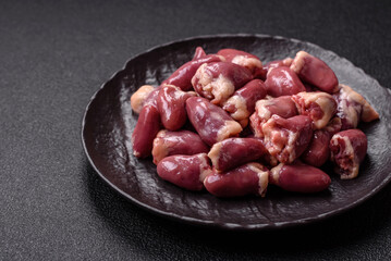 Raw chicken hearts with salt, spices and herbs