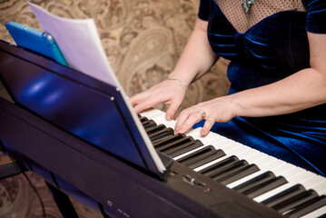 Woman play keys piano, musician pianist performs at concert in nightclub bar