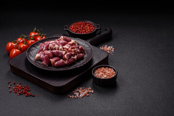 Raw chicken hearts with salt, spices and herbs