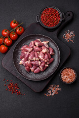 Raw chicken hearts with salt, spices and herbs