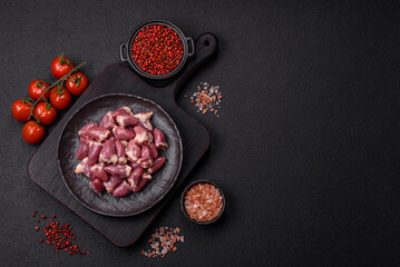 Raw chicken hearts with salt, spices and herbs