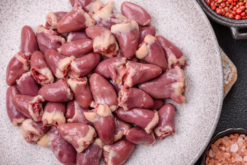 Raw chicken hearts with salt, spices and herbs