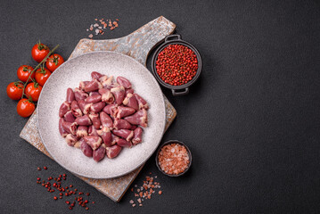 Raw chicken hearts with salt, spices and herbs
