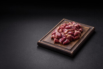 Raw chicken hearts with salt, spices and herbs